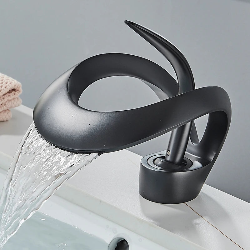Solid brass waterfall basin faucet by MC THE BLACK DIAMOND with single handle for hot and cold water, designed for bathroom sinks.