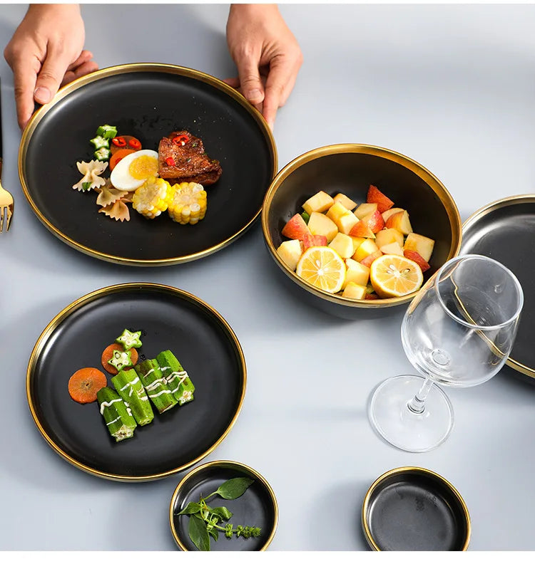 Set of matte gold inlay black porcelain dinnerware from MC THE BLACK DIAMOND, including plates and bowls for kitchen use.