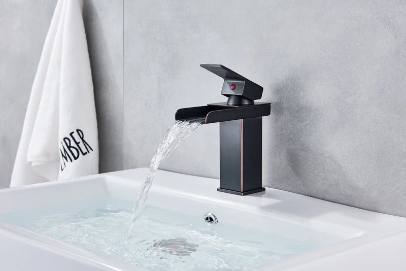 Black Waterfall Bathroom Faucet by MC THE BLACK DIAMOND above a sleek basin vessel sink for modern bath decor.