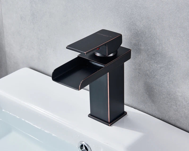 Black waterfall bathroom faucet and vessel sink by MC THE BLACK DIAMOND, featuring sleek, modern design and water flow details.