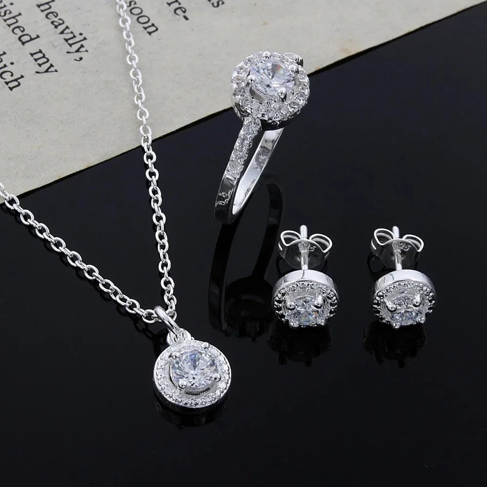 Silver jewelry set with zircon crystals including necklace, ring, and earrings from 𝕄𝕔 𝕋𝕙𝕖 𝔹𝕝𝕒𝕔𝕜 𝔻𝕚𝕒𝕞