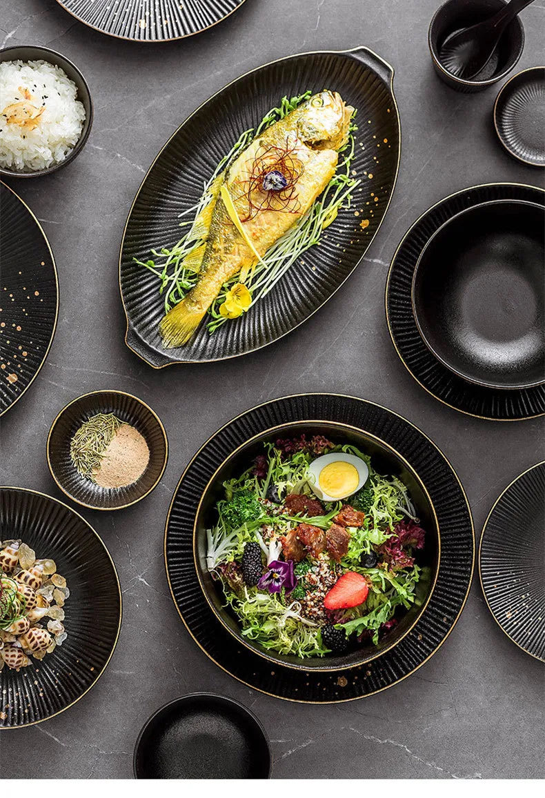 Set of black porcelain dinner plates with gilt rims, including food trays and bowls, from ๐๐ ๐๐๐ ๐น๐๐๐๐ ๐ป๐๐