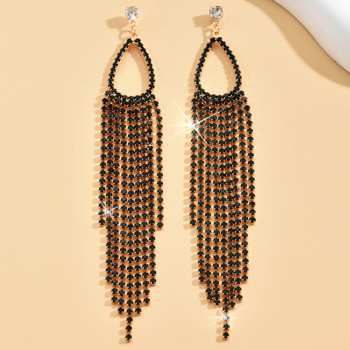 Two women's jewelry rhinestone tassel earrings from MC The Black Diamonds featuring sparkling stone accents and elegant tassel design.