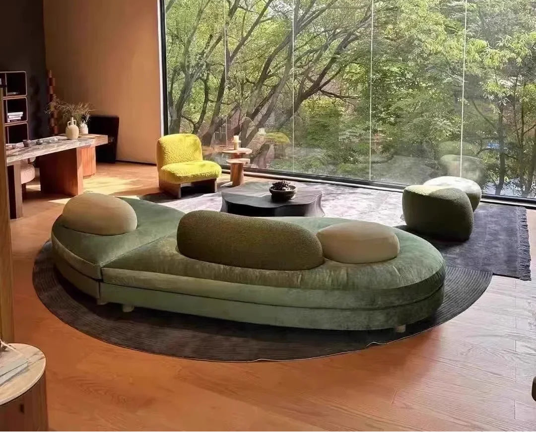 Large green fabric sectional sofa by MC THE BLACK DIAMOND featuring French pebble design, modular love seat with arc-shaped section.