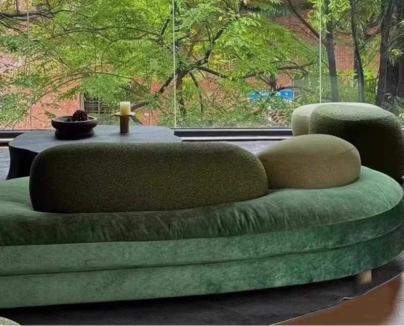 Green fabric sectional sofa by MC THE BLACK DIAMOND featuring large French pebble design and curved modular seating.