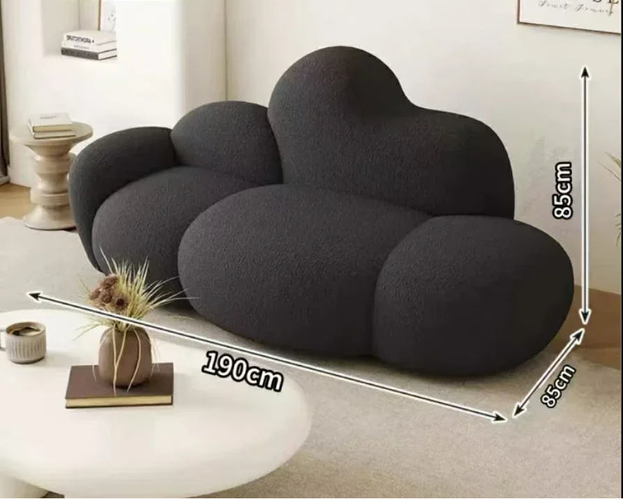 White MC THE BLACK DIAMOND sofa in a living room setting, showcasing a comfortable, relaxing lounge with plush cushions.