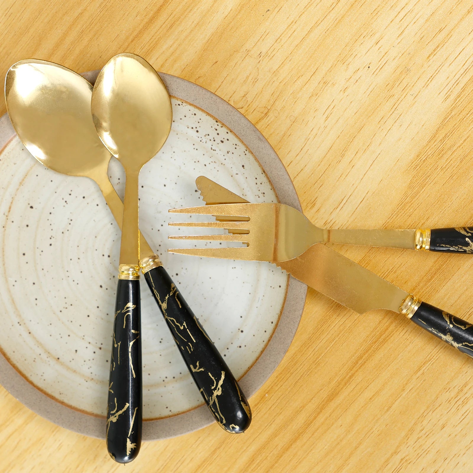 Stainless steel 24-piece flatware set with holder from MC THE BLACK DIAMOND, includes forks, knives, and spoons arranged neatly.