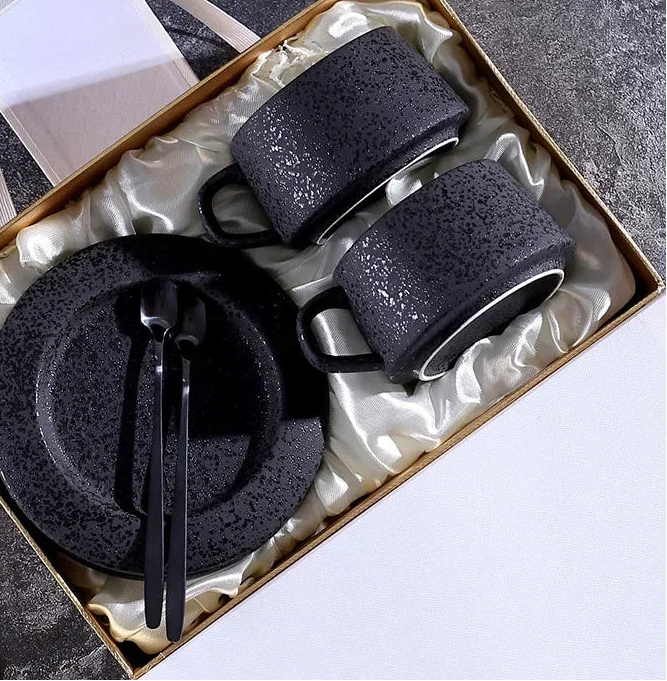 High-grade frosted ceramic coffee cup and saucer set with black spoon and cup holder, designed for breakfast in a stylish kitchen setting.
