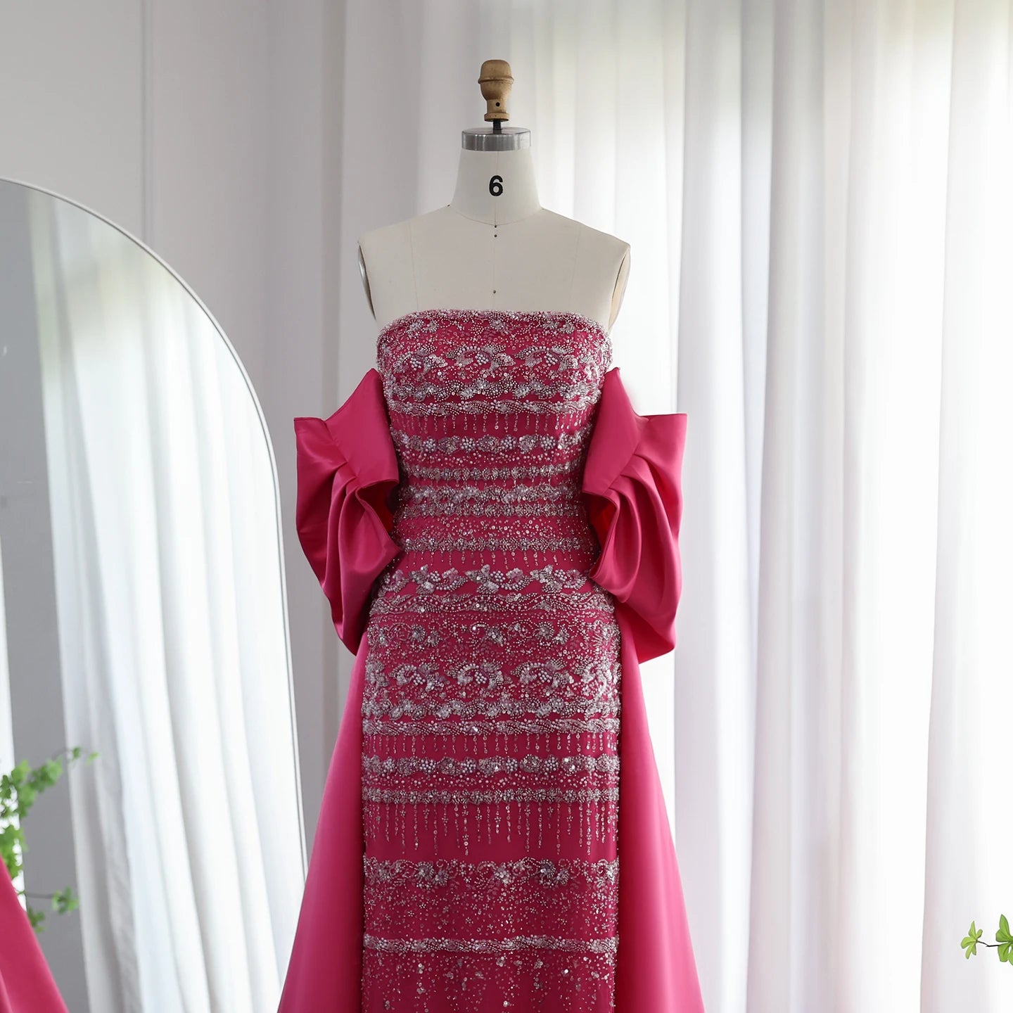 Elegant sage green evening dress by MC THE BLACK DIAMOND, featuring a flowing design and sophisticated style for formal occasions.