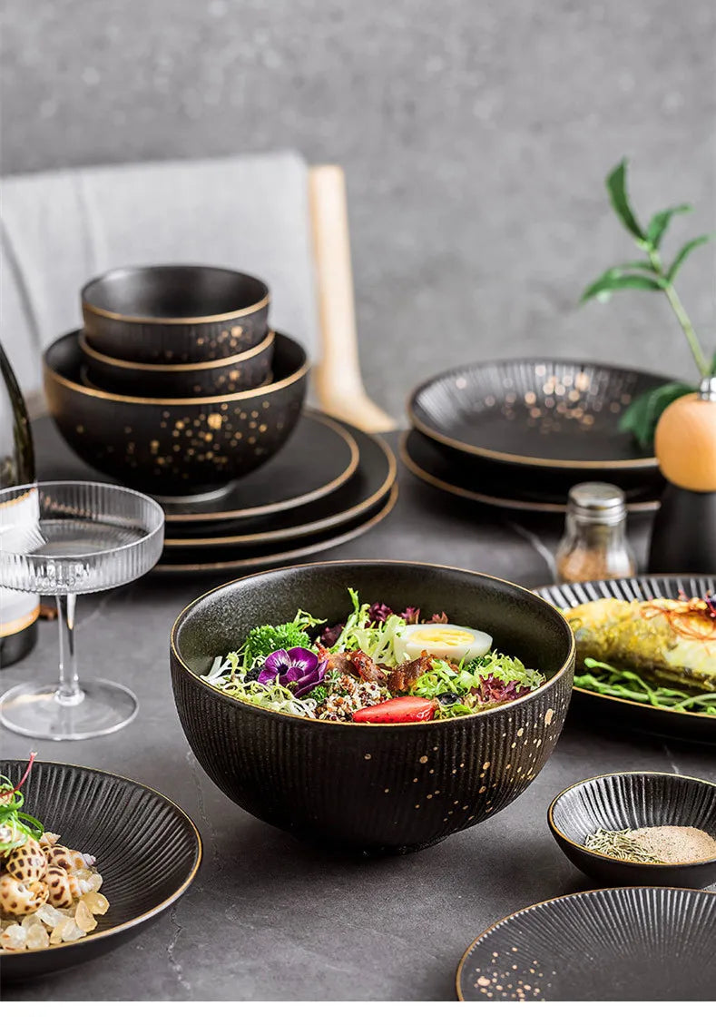 Black porcelain dinner plates with gilt rims from ๐๐ ๐๐๐ ๐น๐๐๐๐ ๐ป๐๐๐๐ ๐