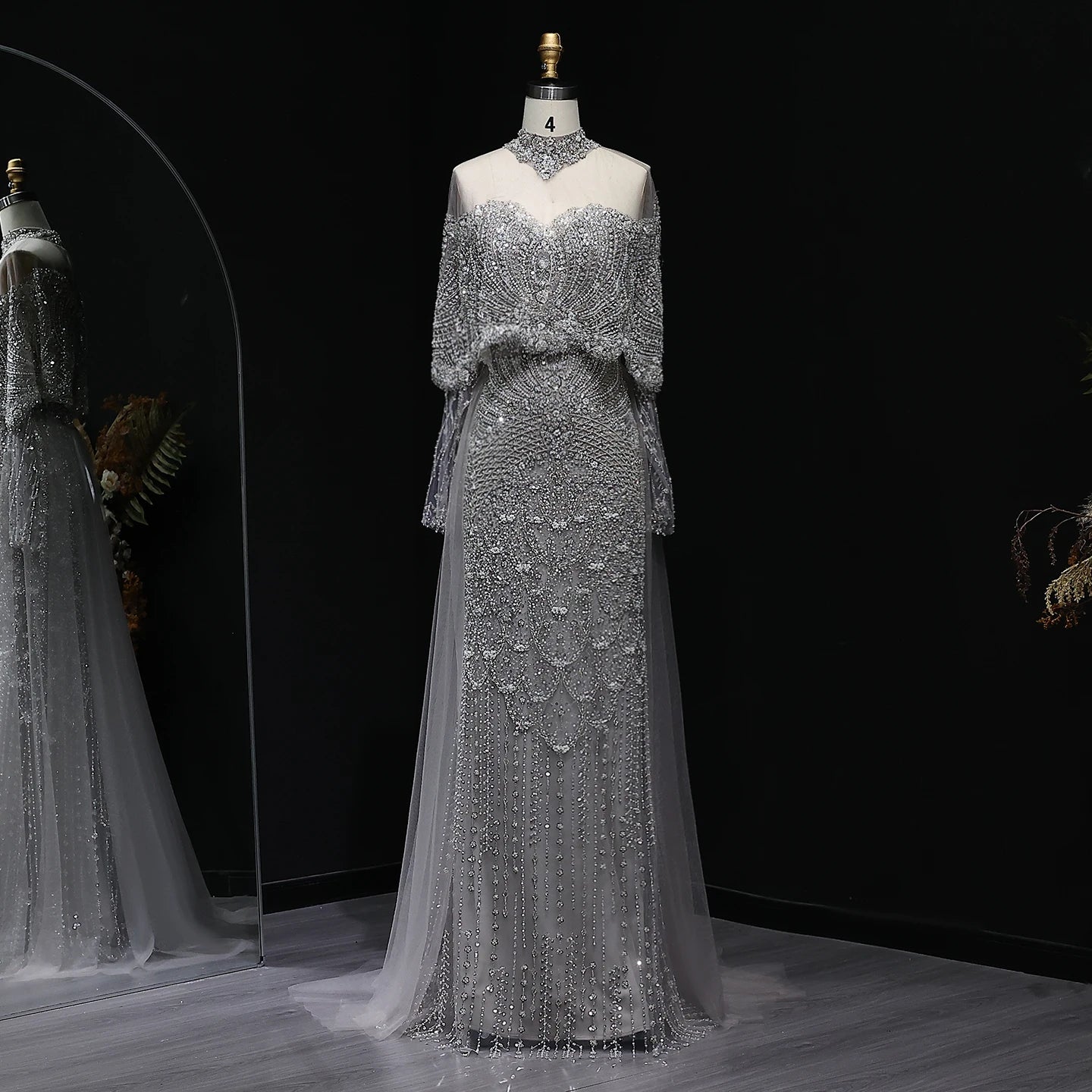 Beaded grey Arabic evening dress by MC THE BLACK DIAMOND featuring intricate beadwork and elegant design for formal occasions.