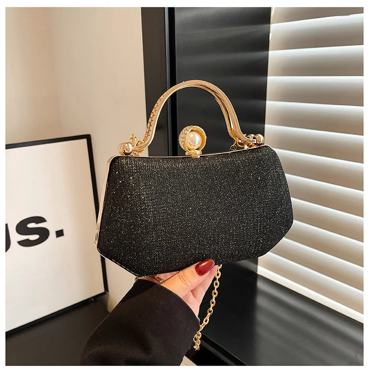 Black MC The Black Diamonds hand bag with solid color, chain strap, and simple crossbody design for versatile evening wear.