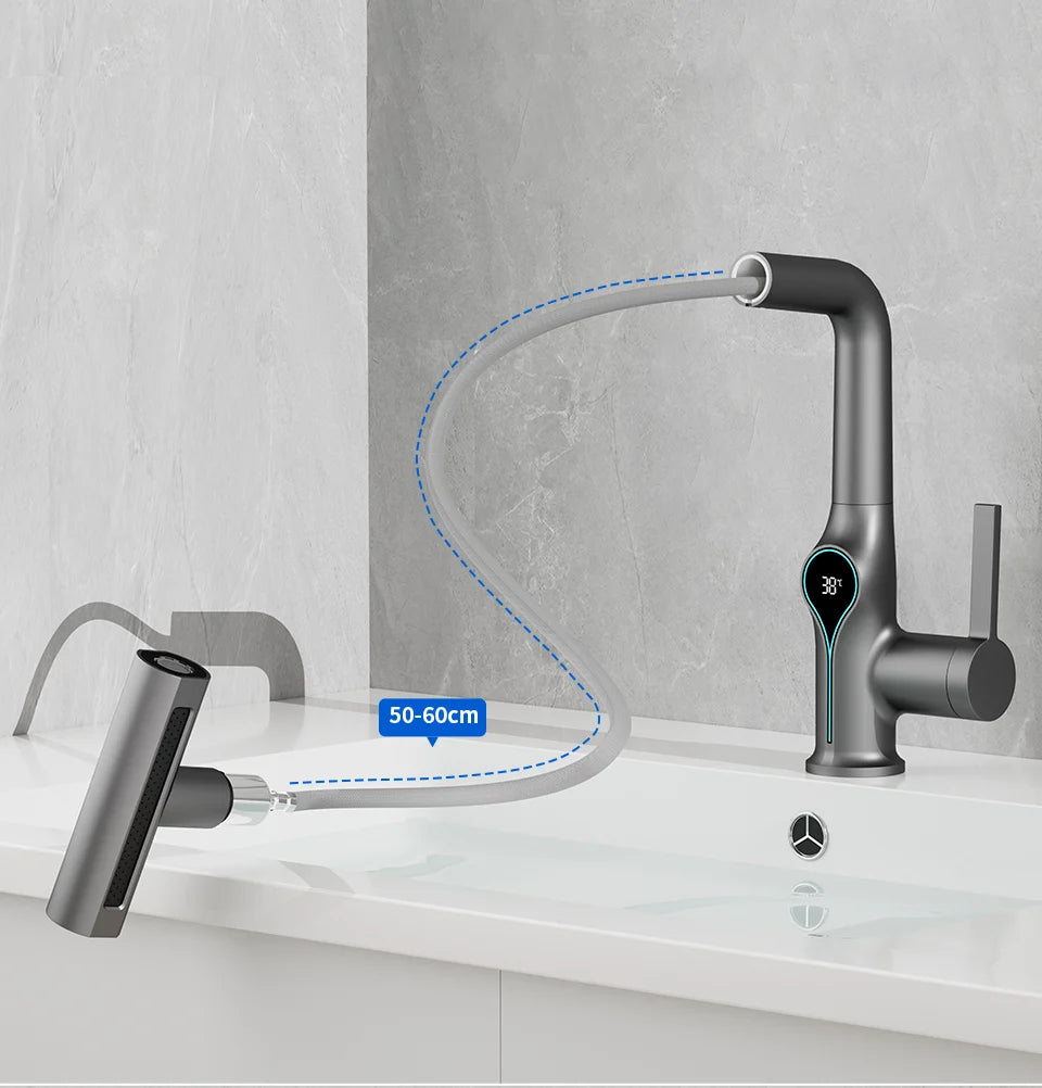 Waterfall basin faucet with digital temperature display, hot and cold water controls, and stream sprayer for bathroom use.