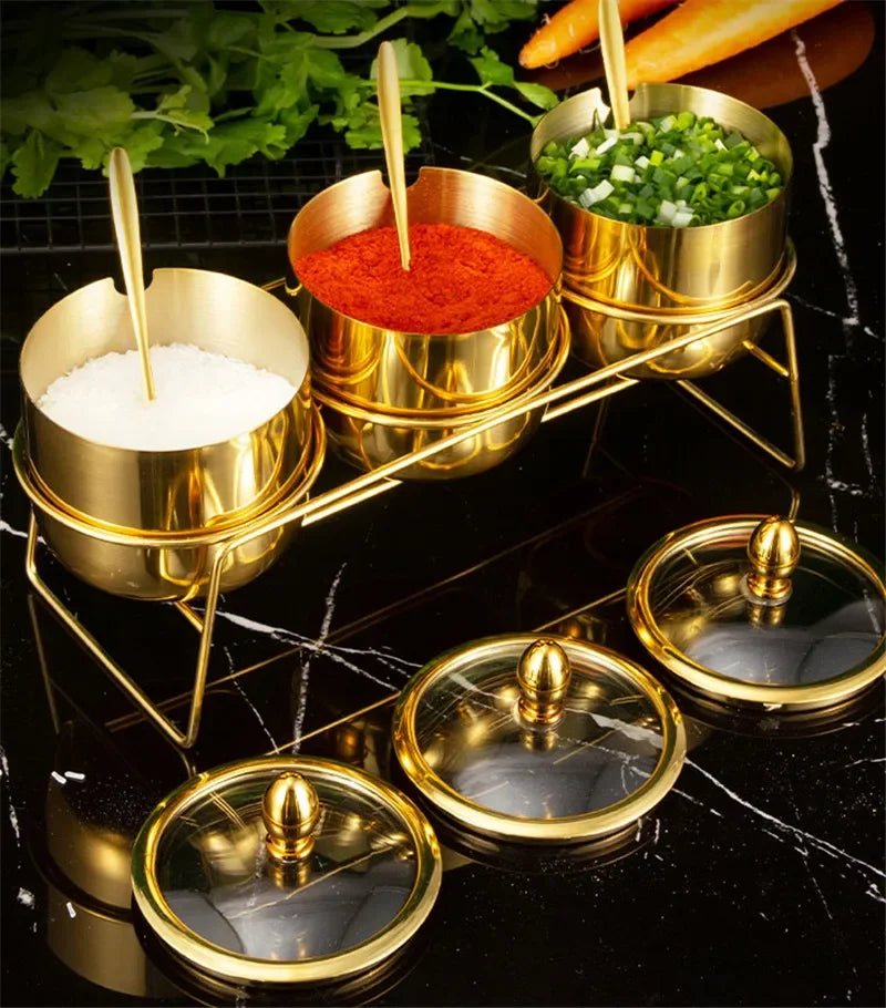 Gold MC THE BLACK DIAMOND 304 seasoning box with glass cap, spoon, and spice jars for salt, sauce, and flavoring storage in the kitchen.