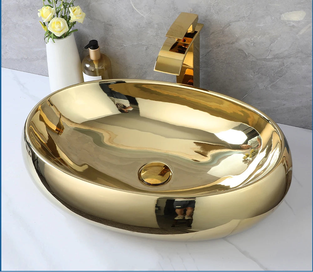 KEMAIDI luxury 23-inch gold ceramic bathroom vessel sink with oval shape and gold waterfall faucet mixer, above counter installation.