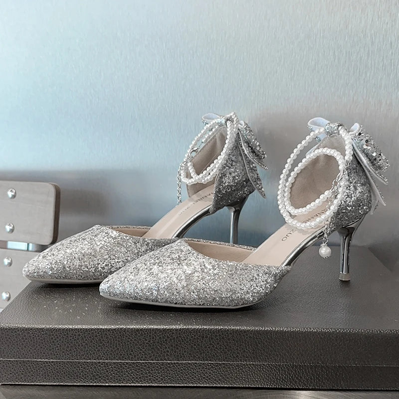 Elegant women's high heels by Mohammand Collection featuring French pointy toes, sequin bows, pearls, and a shallow mouth design.
