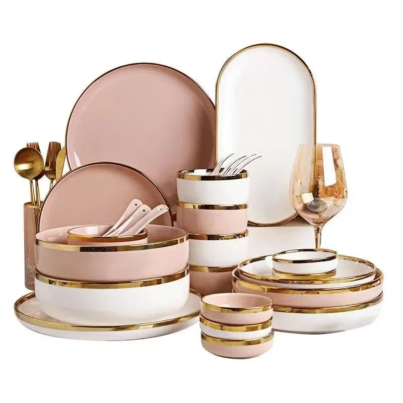Set of white and pink porcelain plates with gold trim by MC THE BLACK DIAMOND, perfect for elegant kitchen table settings.