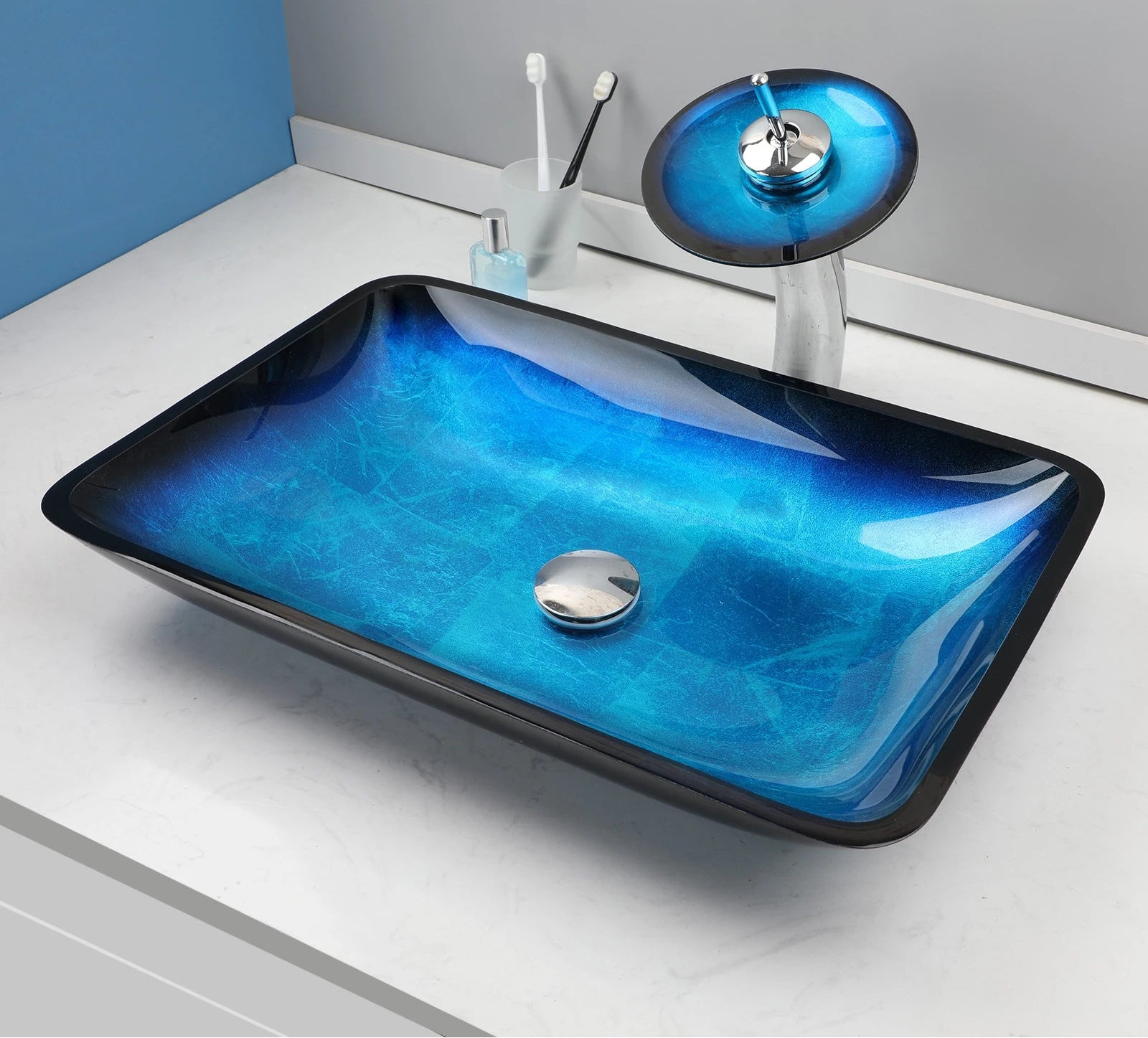 Black tempered glass vessel sink with blue oval basin and waterfall faucet, featuring an above-counter bathroom basin by MC THE BLACK DIAMOND.