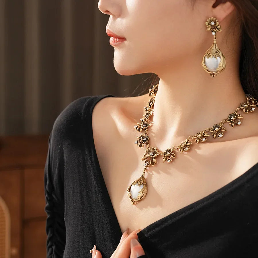 Vintage light luxury jewelry set with flower pendant, pearl earrings, and high-end necklace from Mohammah Collection.