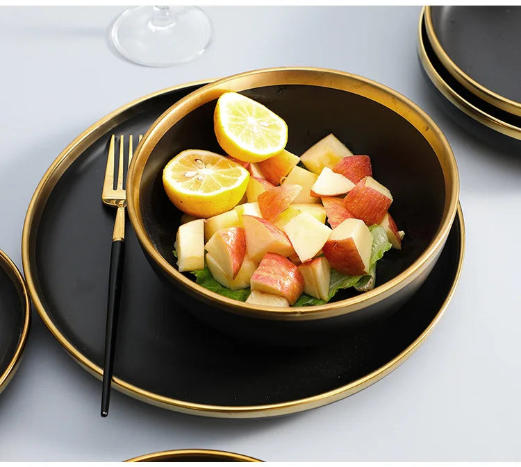 Set of matte gold inlay black porcelain dinnerware from MC THE BLACK DIAMOND, including plates and bowls for kitchen use.