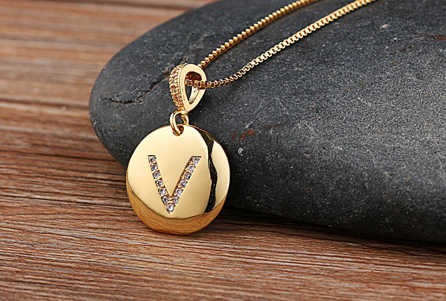Gold initial letter necklace featuring a letter pendant with cubic zirconia stones from 𝕄𝕔 𝕋𝕙𝕖 𝔹𝕝𝕒𝕔𝕜 𝔻𝕚𝕒𝕞