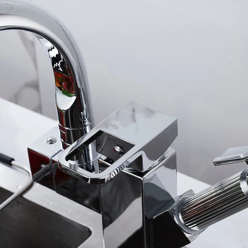Black deck-mounted kitchen sink faucet by MC THE BLACK DIAMOND with flexible pull-out spray, spring spout, hot and cold water controls