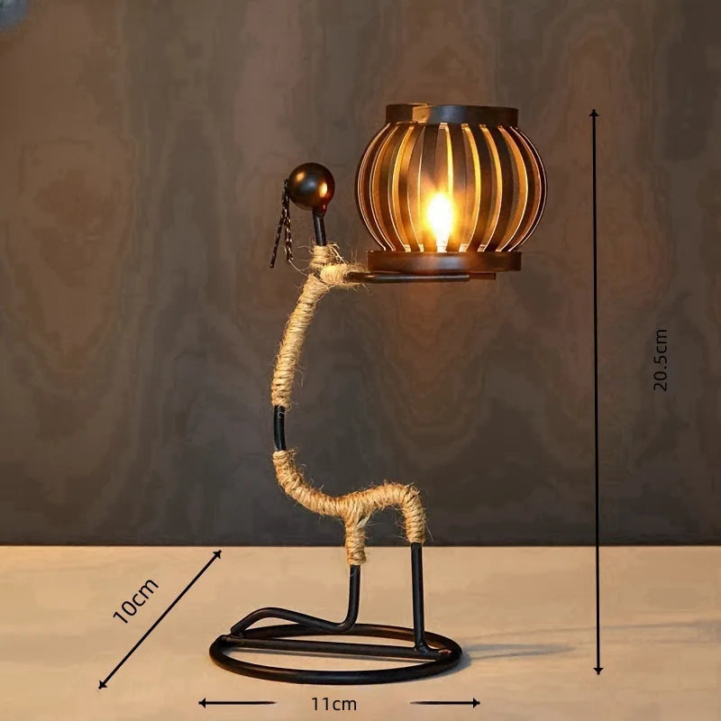 Nordic metal candle holder featuring an abstract character sculpture by 𝕄𝕔 𝕋𝕙𝕖 𝔹𝕝𝕒𝕔𝕜 𝔻𝕚𝕒𝕞𝕠