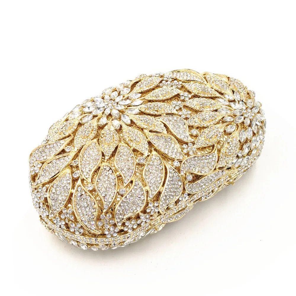 Gold metal leaves and white crystal evening clutch bag by MC THE BLACK DIAMOND, elegant mini heart-shaped handbag for wedding and party events.