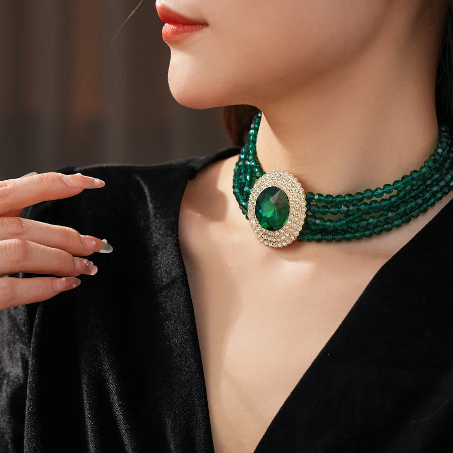 Elegant green jewelry set by MC THE BLACK DIAMOND featuring rhinestone necklace and earrings with inlaid glass rhinestones for women.
