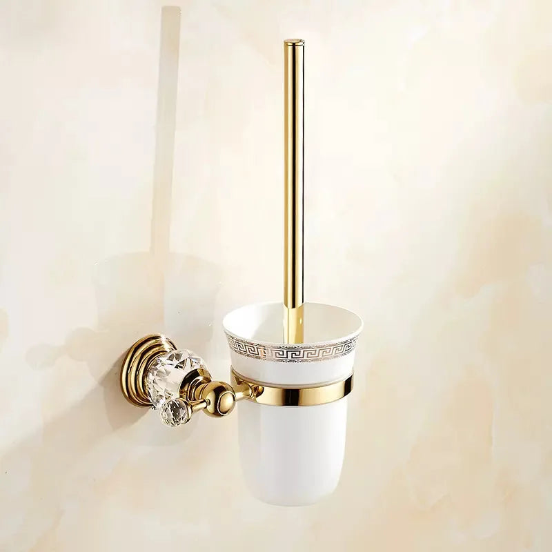 Luxury gold polished brass bathroom accessories set with wall-mounted crystal hardware, including soap dish, towel ring, and toilet paper holder.