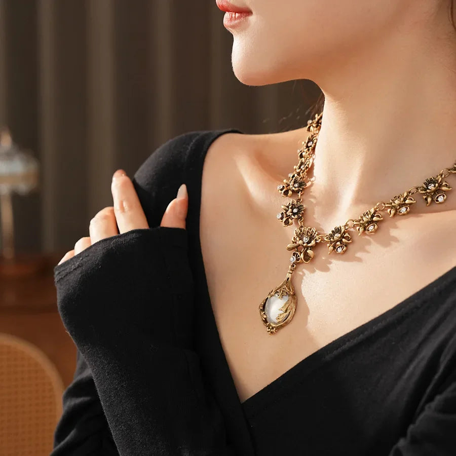 Vintage light luxury jewelry set with rhinestone flower pendant, pearl earrings, and high-end retro bride necklace from Mohammad Collection.
