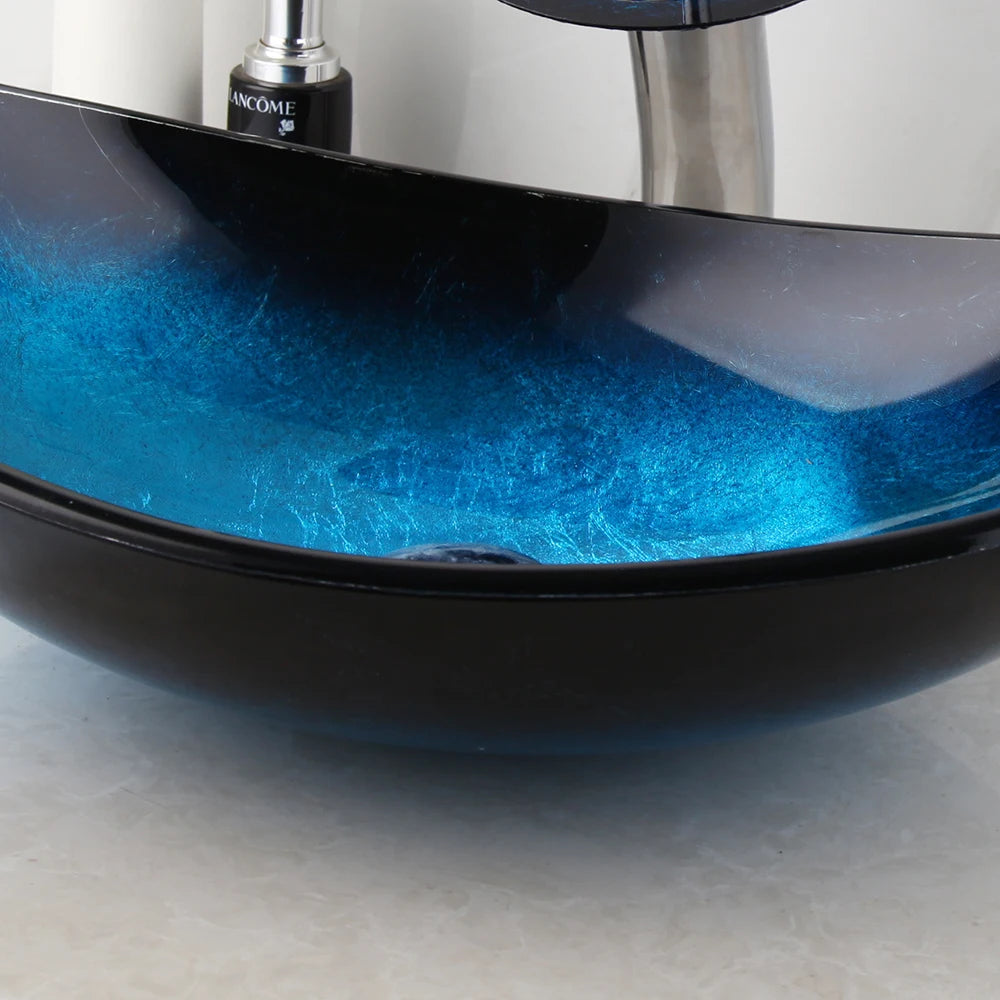 MC THE BLACK DIAMOND ZAPPO tempered glass bathroom vessel sink with black waterfall faucet, oval blue above-counter basin.