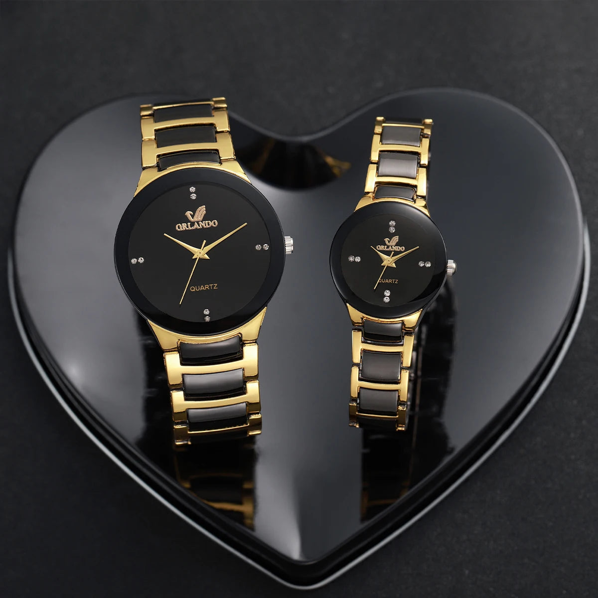 Matching couple's watches by MC The Black Diamonds, featuring sleek black bands and elegant round watch faces.
