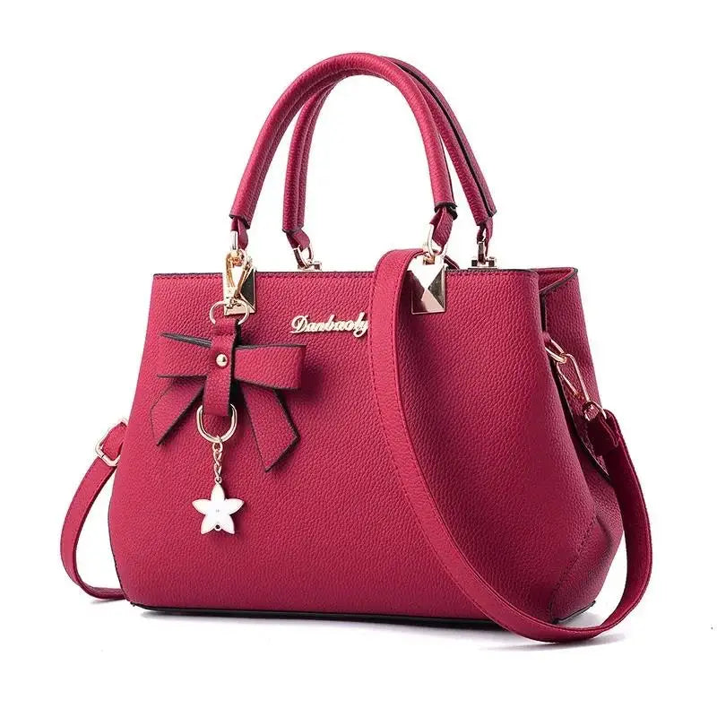 Women messenger bag by MC The Black Diamonds featuring a flower pendant, crossbody tote design, ideal for office and casual use.