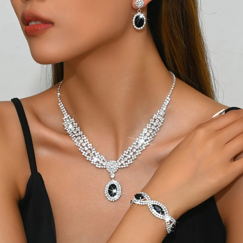 Elegant bridal jewelry set featuring a necklace and earrings with sparkling rhinestones by 𝕄𝕔 𝕋𝕙𝕖 𝔹𝕝𝕒𝕔𝕜 𝔻𝕚𝕒𝕞