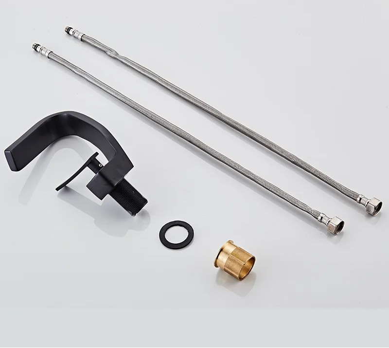 TOLM Brass Black Gold bathroom sink faucet with sleek modern design and dual handles, installed on a bathroom vanity.