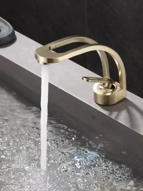 Black and white bathroom mixer tap by MC THE BLACK DIAMOND, mounted on a wash basin with gold accents, designed for the bath.