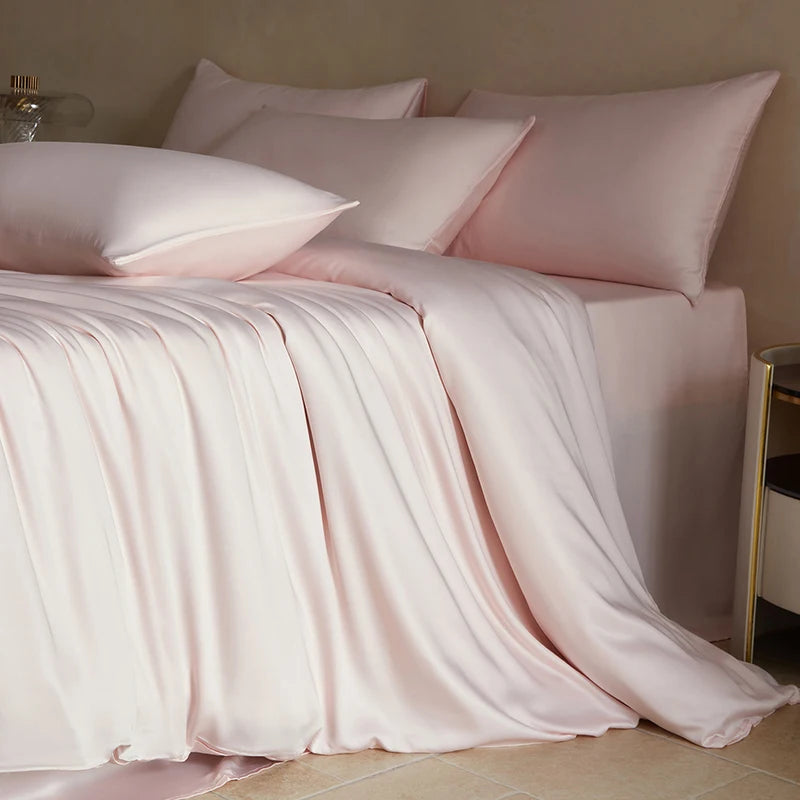 Soft white MC Collection 100% Mulberry Silk Bedding Set with smooth silk sheets and pillowcases, showcasing luxurious home decor.
