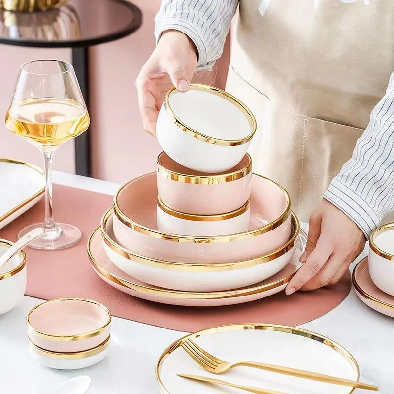 Set of bright white and pink porcelain plates with gold accents, from MC THE BLACK DIAMOND kitchenware collection.