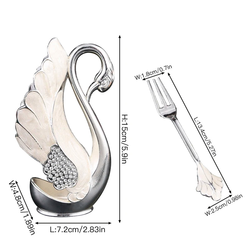 Swan-shaped fruit fork and spoon set in stainless steel from 𝕄𝕔 𝕋𝕙𝕖 𝔹𝕝𝕒𝕔𝕜 𝔻𝕚𝕒𝕞�