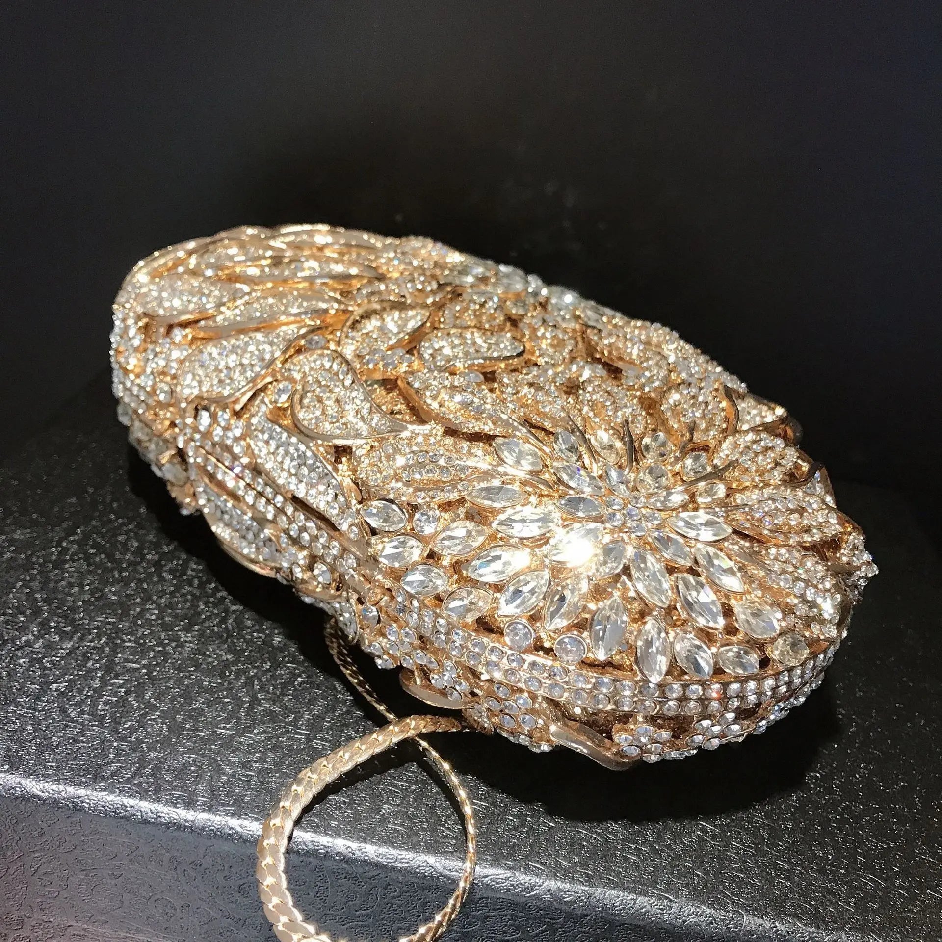 Gold metal leaves and white crystal evening clutch bag by MC THE BLACK DIAMOND, luxury women’s wedding and party mini handbag with rhinestones