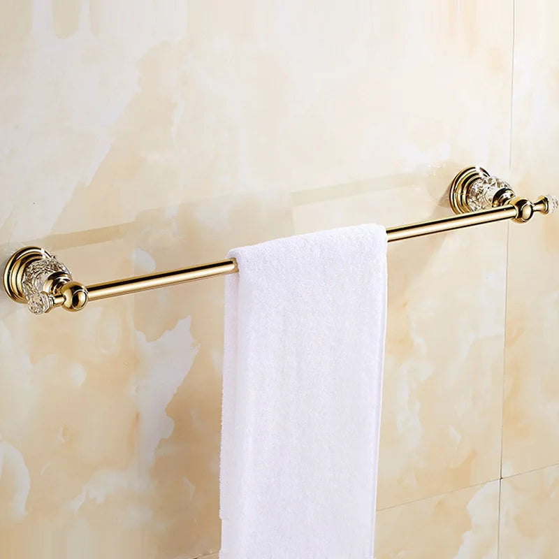 Luxury gold polished brass bathroom accessories set with wall-mounted crystal hardware, includes soap dish, towel ring, and toilet paper holder.