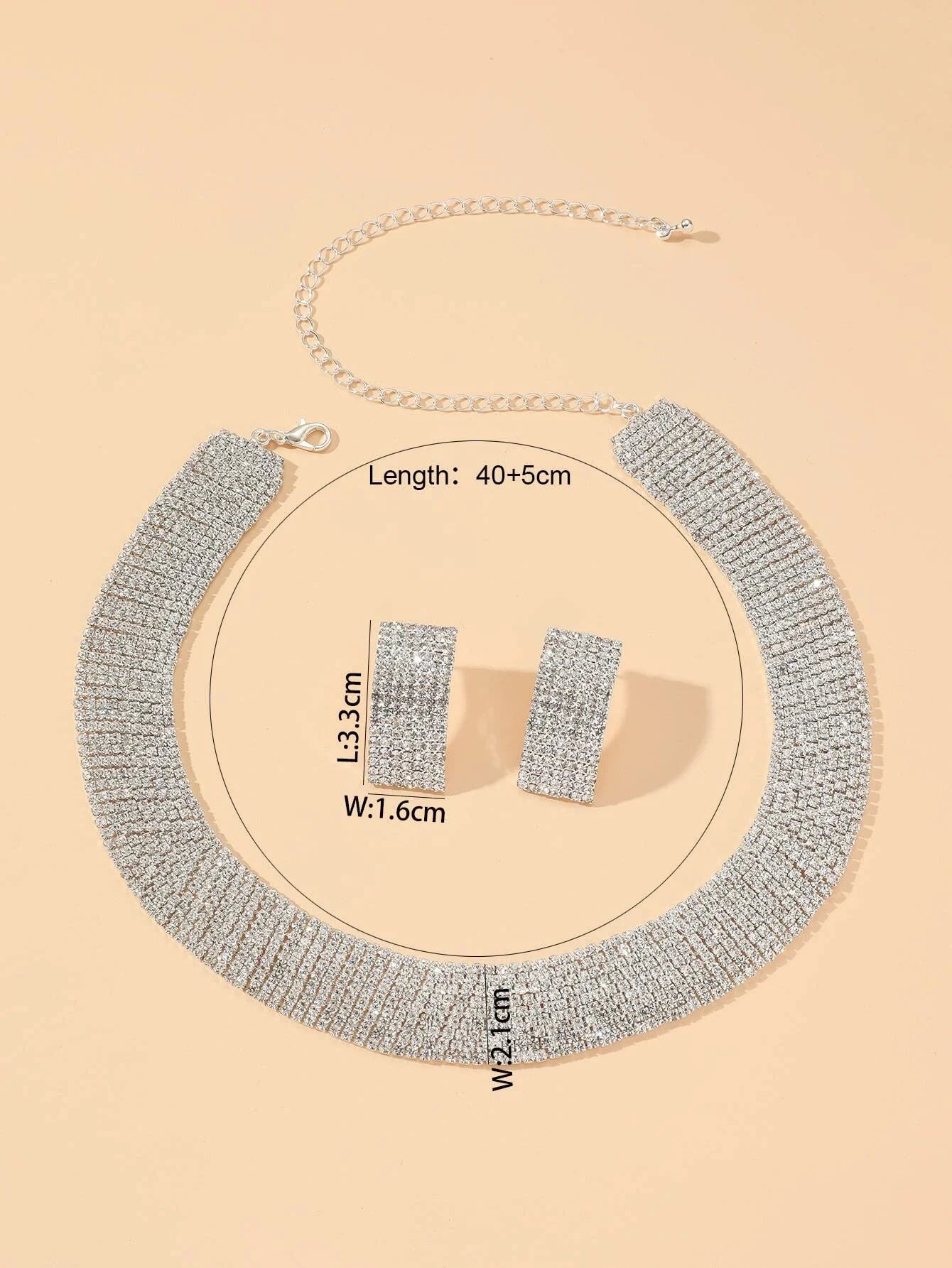 Women's jewelry set with rhinestone earrings and necklace by MC The Black Diamonds featuring sparkling diamond accents.
